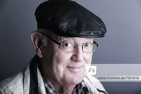 Senior citizen  elderly man  with a cap and glasses  portrait