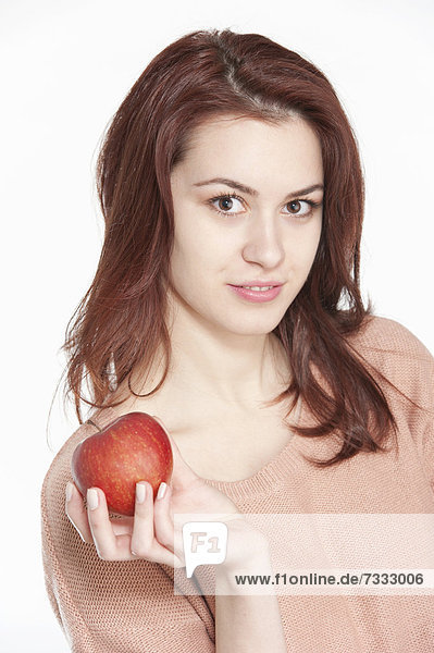 Young woman holding apple