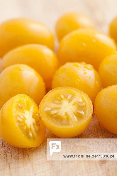 Yellow plum tomatoes on a cutting board