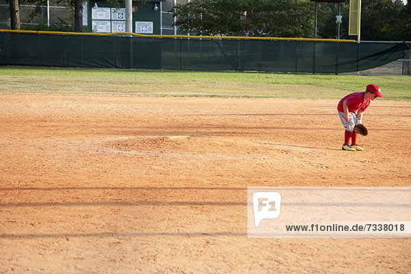 A young baseball player on a baseball diamond