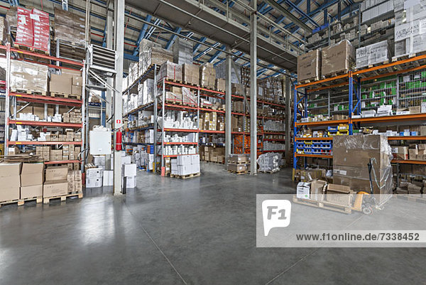Warehouse with cardboard boxes on pallet truck