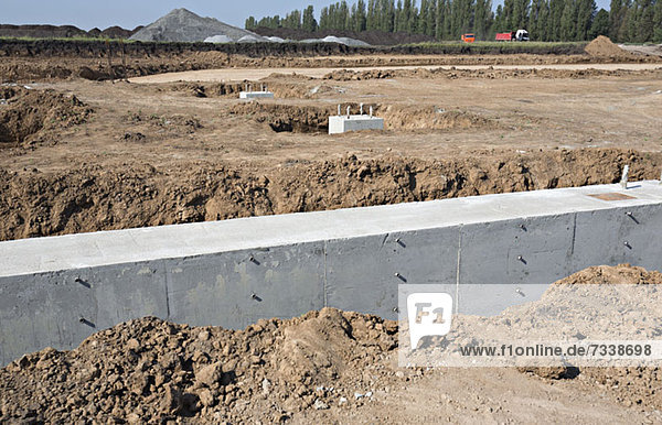 A concrete foundation wall at a construction site