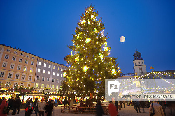 Christmas market stalls and Christmas tree at night at Salzburg market  Austria  Europe