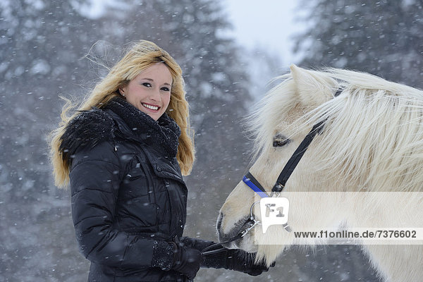 Young woman with horse in snow  Upper Palatinate  Germany  Europe