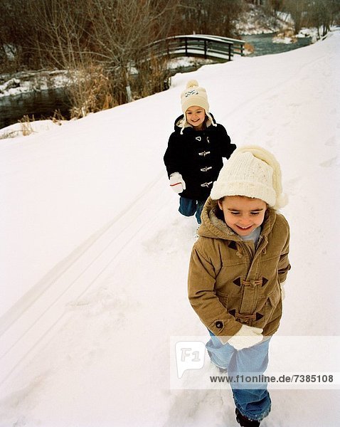 Two boys walking in snow