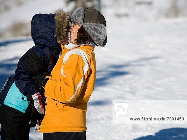 Woman with young girl outdoors in winter