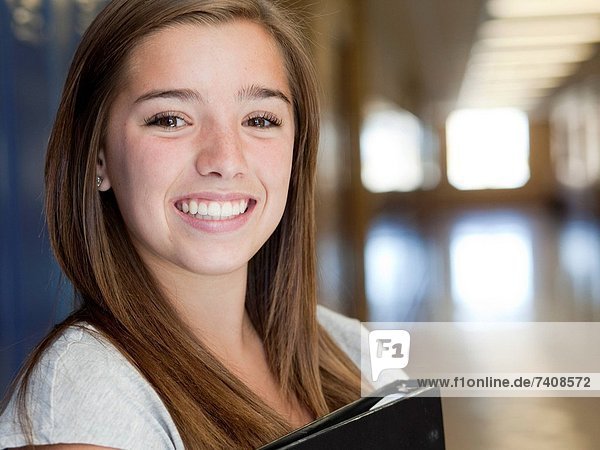 USA Utah Spanish Fork Portrait of school girl 16_17 holding file in corridor