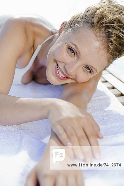 Woman laying on towel outdoors