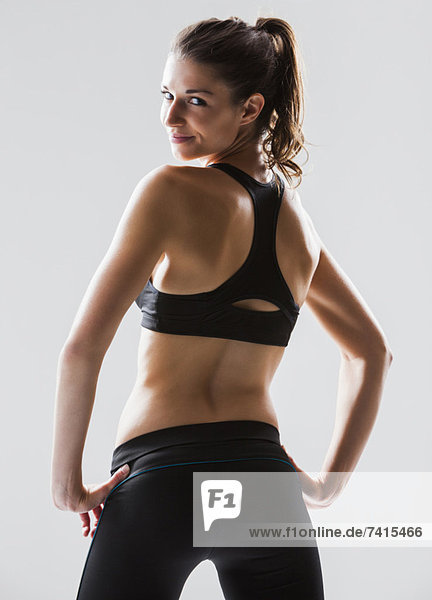 Portrait of young woman exercising  studio shot