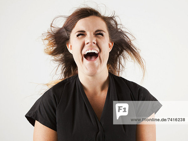 Studio portrait of young woman screaming