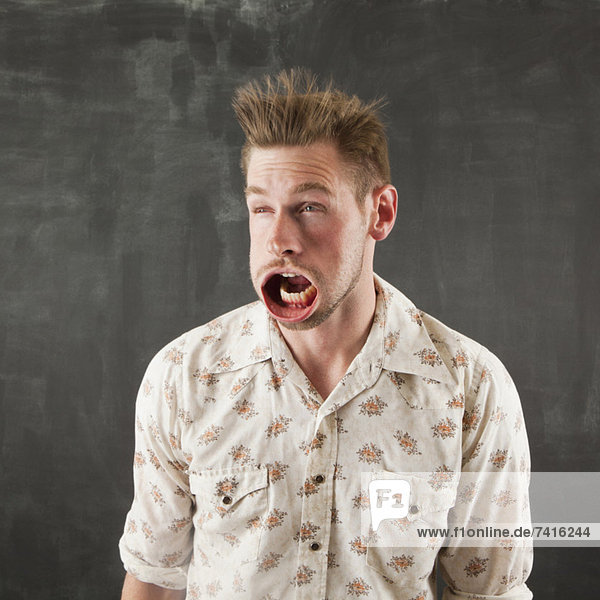 Studio shot of man with windblown mouth