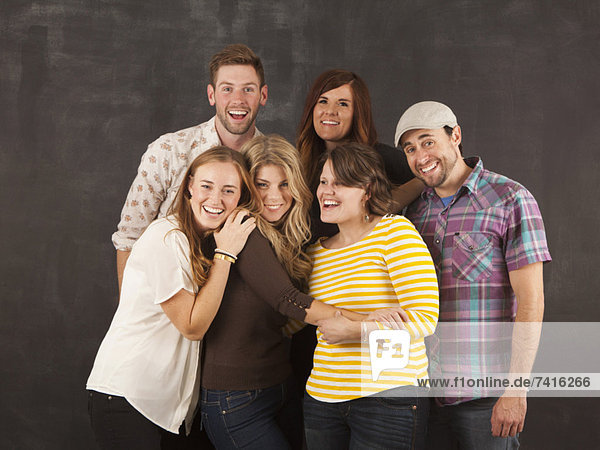 Studio portrait of group of friends embracing