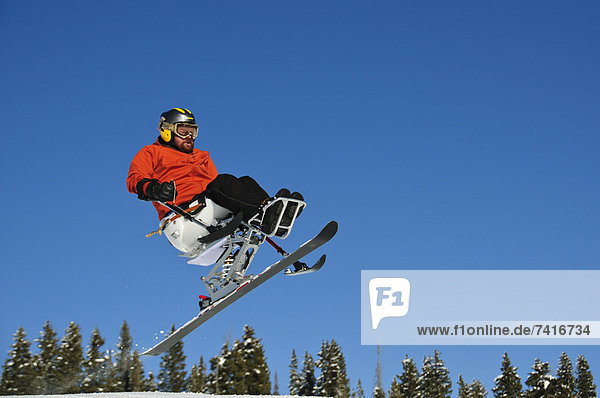 A handicap skier in air.
