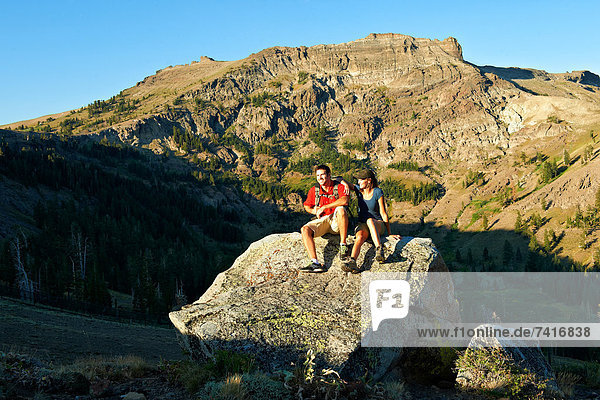 A couple enjoys the beauty of a Summer hiking adventure.