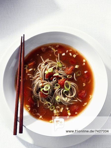 Tomato soup with soba noodles and spring onions (Asia)
