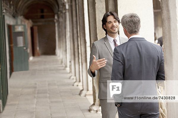 Businessmen talking in corridor