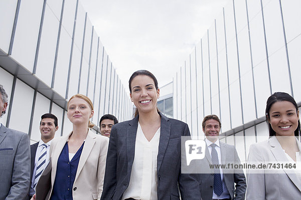 Portrait of smiling business people walking