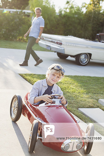 Smiling boy playing in go cart