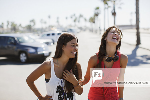 Laughing women walking outdoors
