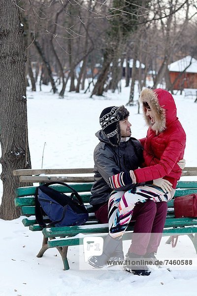 Couple spending a day in a snowy park in Bucharest  Romania