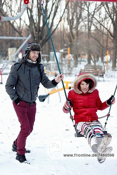 Couple spending a day in a snowy park in Bucharest  Romania