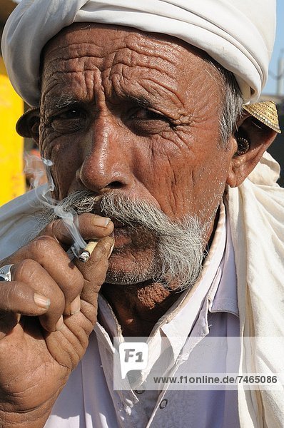 Smoking beedies by men in rural India  Gujarat  India  Asia