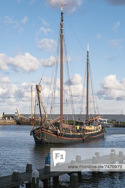 Traditional Dutch merchant ship sailing into Volendam harbour  North Holland Province  The Netherlands (Holland)  Europe
