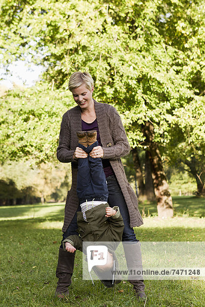 Mother and son playing in park