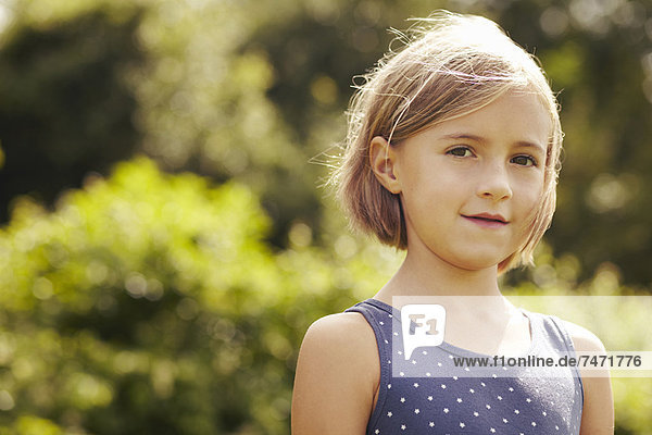 Smiling girl standing outdoors
