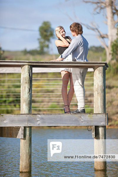 Couple smiling on wooden deck