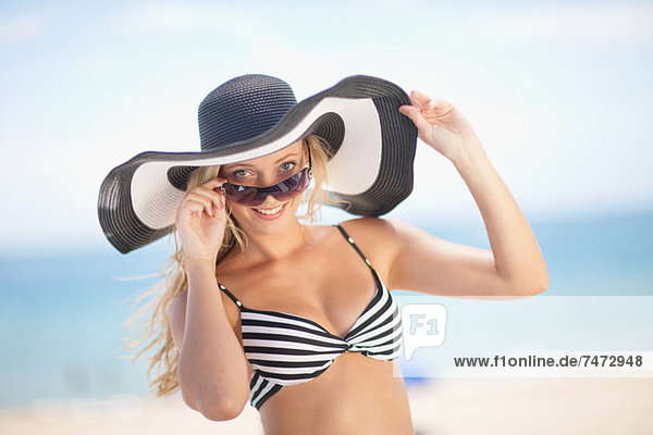 Woman wearing bikini and floppy hat