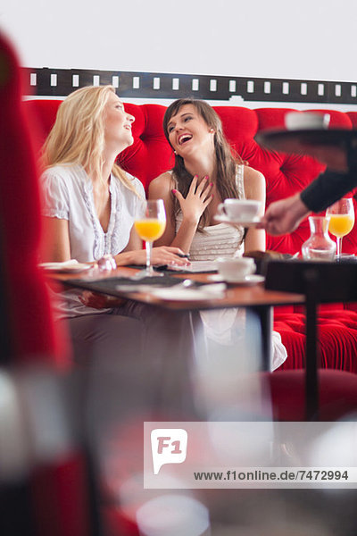 Women having breakfast together in cafe