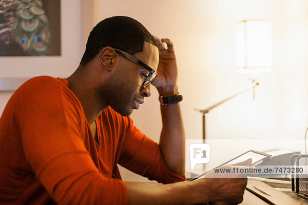 Man using tablet computer at desk