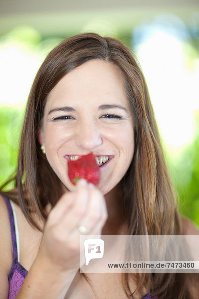 Woman eating fruit outdoors