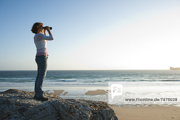 Woman Looking into the Distance Using Binoculars at the Beach  Camaret-sur-Mer  Crozon Peninsula  Finistere  Brittany  France