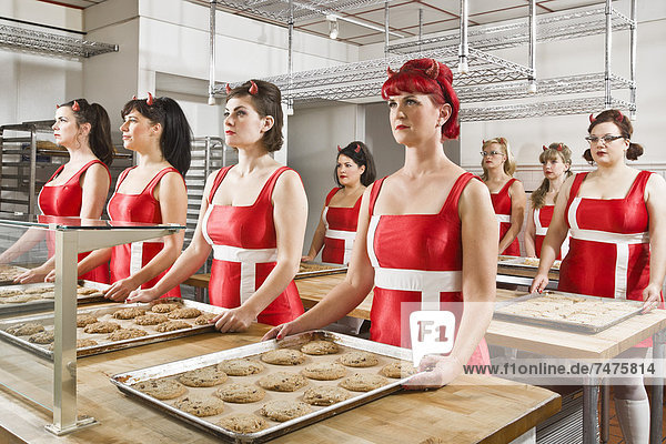 Women Wearing Devil Horns Working at a Bakery  Oakland  Alameda County  California  USA