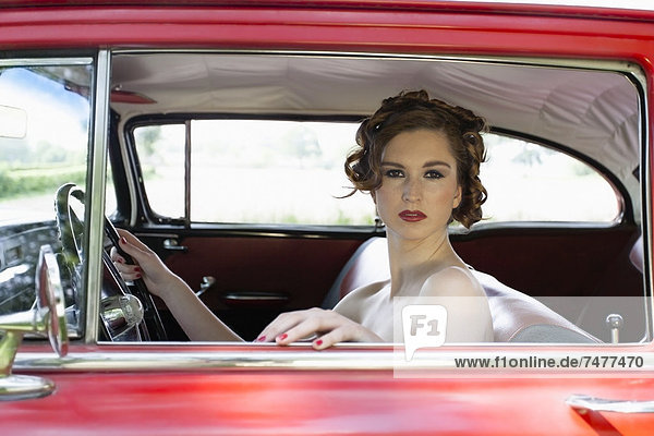 Portrait of elegant woman in vintage car