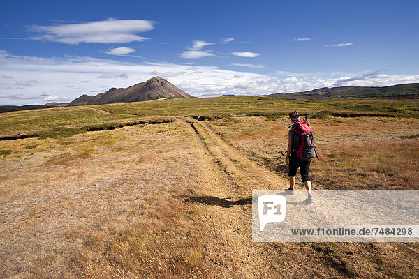 Young woman trekking with a backpack  Krafla  North Iceland  Iceland  Europe