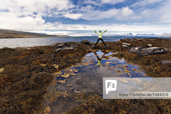 Reflection of a young woman in a pond  Westfjords  Iceland  Europe