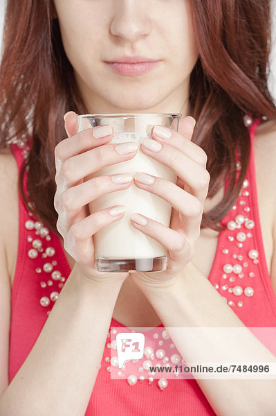 Young woman holding a glass of milk