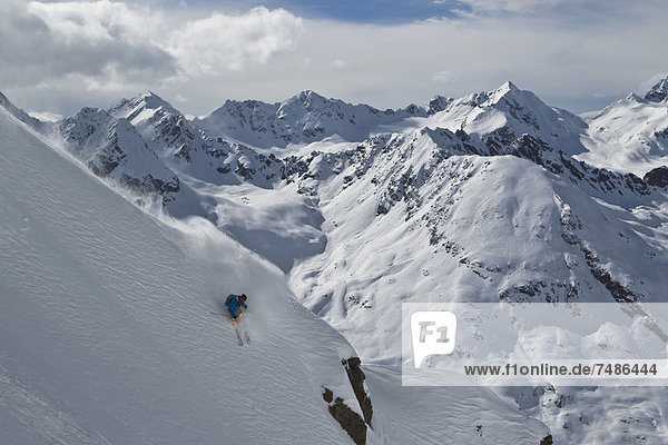 Austria  Tirol  Young man doing freeride skiing