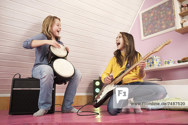 Girls playing guitar and drums  laughing