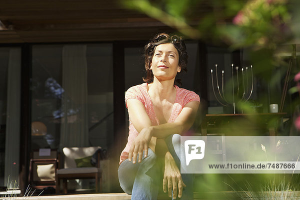 Mature woman relaxing on terrace
