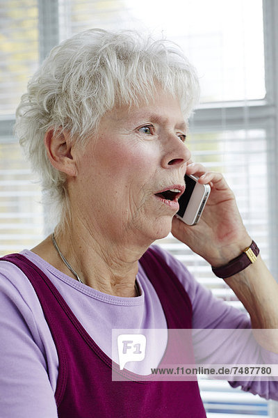 Senior woman talking on mobile phone  close up
