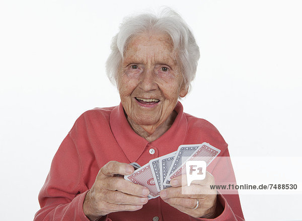 Portrait of senior woman playing cards  close up