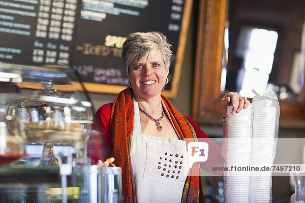 Caucasian woman working in coffee shop