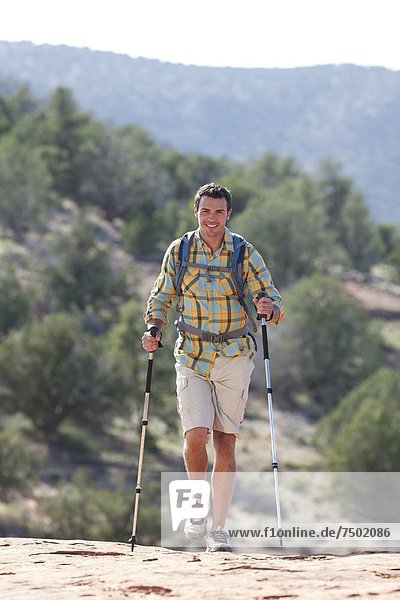 USA  Arizona  Sedona  Young man hiking in desert