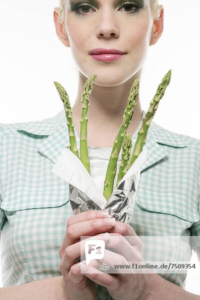 Young woman holding asparagus