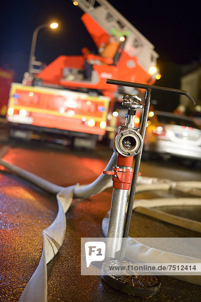 Standpipe on an underground hydrant a turntable ladder truck of the Backnang volunteer fire department at the back Stuttgart Baden-Wuerttemberg Germany Europe