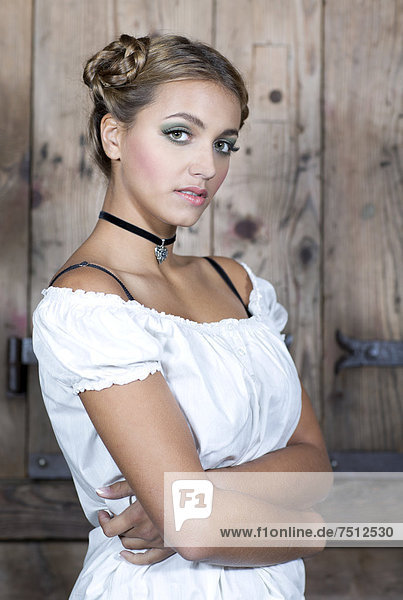Young woman wearing a white dirndl top  portrait  dirndl look